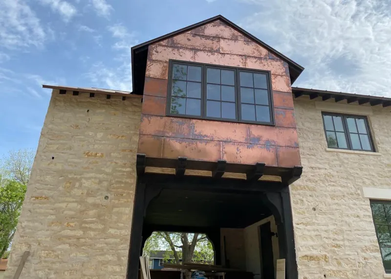 Copper metal panel facade on a stone building for Skylight Installation in Dallas